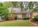 Brick home with a covered entryway and well-manicured lawn at 208 Eastwood Dr, Salisbury, NC 28146