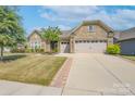 Ranch-style home with stone accents, two-car garage, and a spacious lawn at 3087 Bartlett St, Fort Mill, SC 29715
