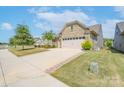 Attractive home with stone exterior, two-car garage, and a well-manicured lawn at 3087 Bartlett St, Fort Mill, SC 29715