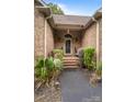 Inviting front entry with brick steps and landscaping at 10235 Mount Holly Rd, Charlotte, NC 28214