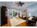 Living room with hardwood floors, fireplace, and ample seating at 10235 Mount Holly Rd, Charlotte, NC 28214