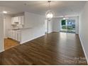Spacious living room featuring hardwood floors and access to balcony at 4432 Eaves Ln, Charlotte, NC 28215
