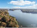 Aerial view of a serene lake with houses along the shoreline at 151 River Ridge Ln, Statesville, NC 28677