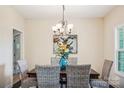 Dining room with a wooden table, wicker chairs, and a chandelier at 531 Tributary Dr # 26, Fort Lawn, SC 29714