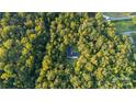 Aerial view showing a house nestled in a lush, wooded area at 9224 Maggie Robinson Rd, Waxhaw, NC 28173