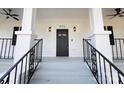 Front porch with black railings and ceiling fan at 615 English St, Monroe, NC 28110