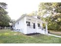 White house with a wrap around porch at 615 English St, Monroe, NC 28110