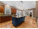 Spacious kitchen with island, hardwood floors, and dark wood cabinets at 124 Streamwood Rd, Troutman, NC 28166