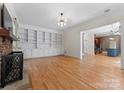 Living room with hardwood floors, built-in shelves, and fireplace at 124 Streamwood Rd, Troutman, NC 28166