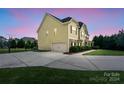 Two story house with a side view of the garage, driveway, and basketball court at 5601 Ballenger Ct, Waxhaw, NC 28173