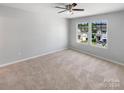 Spacious carpeted bedroom with large windows and ceiling fan at 264 Aershire Ct, Concord, NC 28025