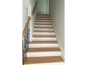 Oak staircase with black metal railing at 830 Oakshire Cir, Charlotte, NC 28214