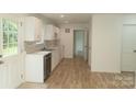 Bright kitchen with white cabinets and wood floors at 830 Oakshire Cir, Charlotte, NC 28214