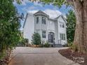 Two-story house with white siding, a dark gray door, and a landscaped yard at 323 Atherton St, Charlotte, NC 28203