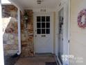 White front door and stone entryway at 7118 Quail Meadow Ln, Charlotte, NC 28210