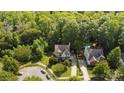 Aerial view of house and surrounding neighborhood, showing driveway and trees at 1229 Brecken Ct, Kannapolis, NC 28081