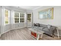 Living room features hardwood floors, large windows, and comfortable seating at 1229 Brecken Ct, Kannapolis, NC 28081