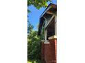 Side view shows fire damage and overgrown vegetation; needs major repairs at 215 S Ervin Ave, Newton, NC 28658