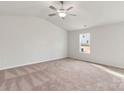 Spacious bedroom with neutral carpeting and a ceiling fan at 146 Adams Tree Way, Troutman, NC 28166