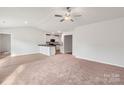 Open living space with hardwood floors and kitchen island at 146 Adams Tree Way, Troutman, NC 28166