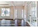 Bright entryway with hardwood floors, white trim, and French doors at 3229 Mcharney Dr # 30, Harrisburg, NC 28075