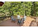 Deck with table and chairs, overlooking woods at 746 Springwood Dr # 14&15, Mount Gilead, NC 27306