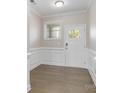 Bright foyer with hardwood floors and wainscoting at 2465 Palmdale Walk Dr, Fort Mill, SC 29708