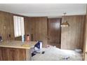 Dated kitchen with wood paneling and linoleum floor at 3114 Thompson Rd, Lancaster, SC 29720