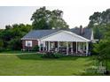 Brick ranch house with a large covered porch at 3021 Davis Park Rd, Gastonia, NC 28052