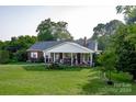 Brick ranch house with a large covered porch at 3021 Davis Park Rd, Gastonia, NC 28052