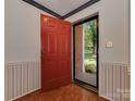 Front entry with red door and hardwood floors at 200 Linville Dr, Matthews, NC 28105