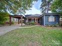 Blue house with a covered wooden pergola and walkway at 1019 Valley St, Kannapolis, NC 28081