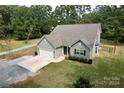 Aerial view of a gray house with a white garage door and surrounding greenery at 924 Marshville Olive Branch Rd, Marshville, NC 28103