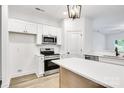 Modern kitchen featuring white cabinets, stainless steel appliances, and a large island at 354 Moore Ave, Mooresville, NC 28115