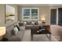 Living room with L-shaped sofa, coffee table, and hardwood floors at 1525 Vanderlip Dr, Gastonia, NC 28052