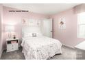 Pink bedroom with a full bed and plenty of natural light at 1211 Bark Mill Rd # 0043, Charlotte, NC 28214