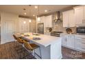 Modern kitchen with white cabinets, stainless steel appliances, and an island with seating at 621 Seldon Dr, Charlotte, NC 28216