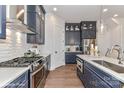 Modern kitchen with dark blue cabinets and a large island at 3016 Endhaven Terraces Ln # 11, Charlotte, NC 28277
