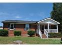 Brick ranch house with a covered front porch at 500 Doffin Ln, Gastonia, NC 28052