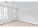 Light and bright entryway with white door and wood-look floors at 335 Davidson Hwy, Concord, NC 28027
