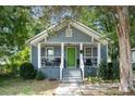 Gray house with green door and porch at 225 Flint St, Charlotte, NC 28216