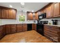 Spacious kitchen with dark wood cabinets, granite countertops, and hardwood floors at 1447 London Dr, Rock Hill, SC 29732