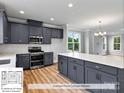 Modern kitchen with dark gray cabinets, quartz countertops, and GE appliances at 222 Gilead Rd, Huntersville, NC 28078