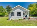 Front view of charming white house with black shutters at 102 Stanton St, Clover, SC 29710