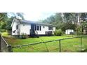 White ranch home with fenced backyard and detached shed at 102 Aderholdt Rd, Bessemer City, NC 28016