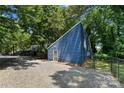 Blue building exterior with gravel and a green chain link fence at 1346 Hill Rd, Charlotte, NC 28210