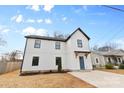 Two-story house, white siding, blue front door, and a concrete driveway at 103 Apricot St, Belmont, NC 28012