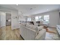 Bright living room with L-shaped sectional sofa and kitchen view at 1816 Teachers House Nw Rd, Concord, NC 28027