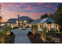 Luxury lakefront home with stone facade and fountain at 19125 Peninsula Point Dr, Cornelius, NC 28031