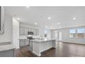 Open kitchen with island, stainless steel appliances, and hardwood floors at 2243 Carpenter Farms Dr, Lincolnton, NC 28092